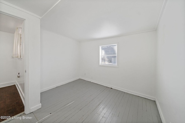 empty room with hardwood / wood-style flooring and baseboards