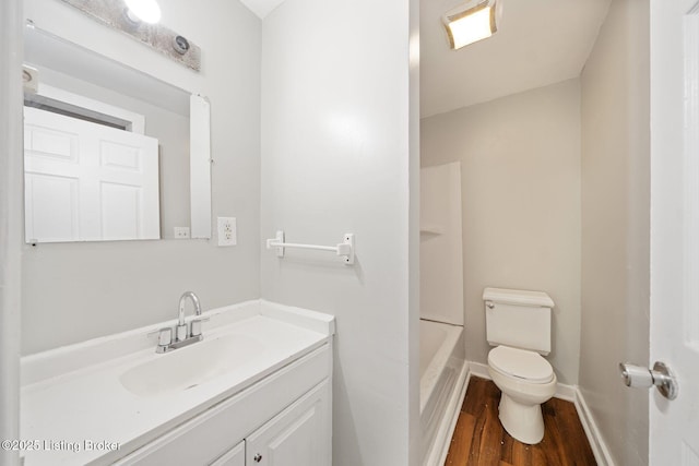 full bathroom with vanity, wood finished floors, toilet, and baseboards