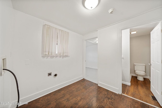 interior space with toilet, visible vents, baseboards, and wood finished floors