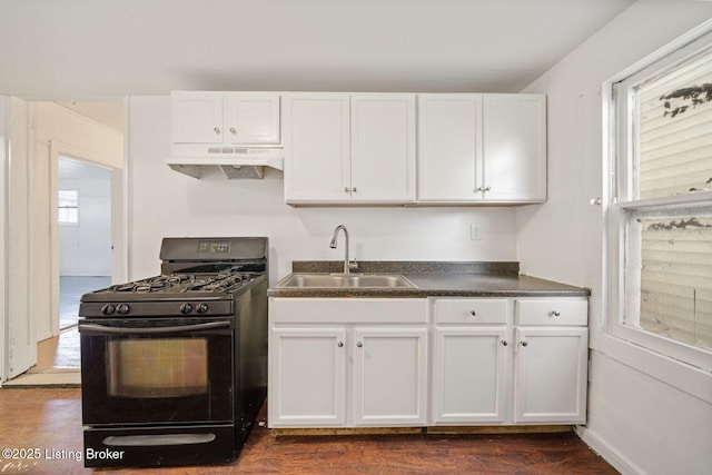 kitchen featuring under cabinet range hood, black range with gas cooktop, white cabinets, and a sink