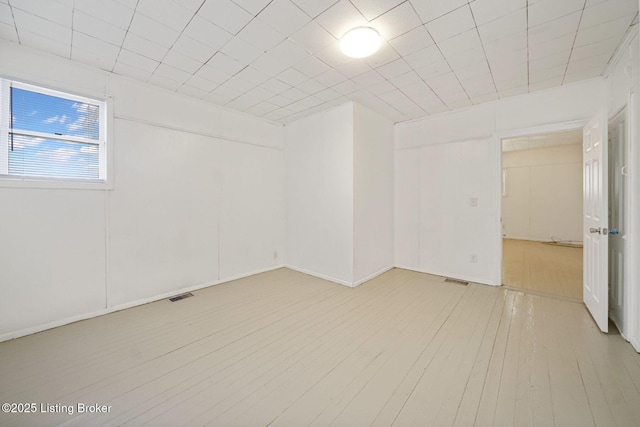 unfurnished room with visible vents and light wood-style flooring