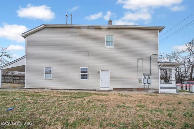 back of house with a yard and fence