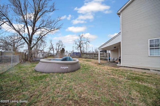 view of yard with a fenced backyard and a swimming pool