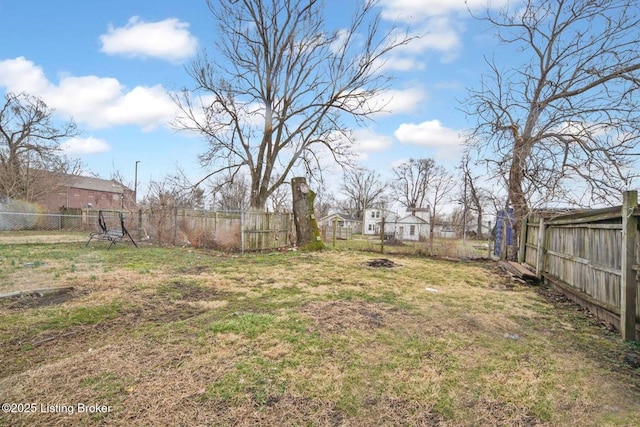 view of yard featuring an outdoor fire pit and a fenced backyard