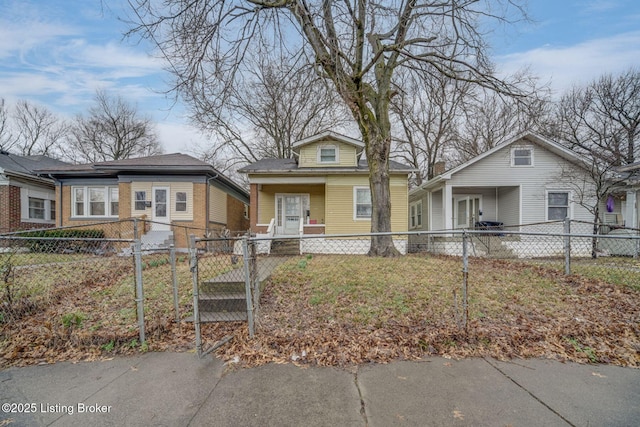 bungalow-style home with a fenced front yard and a gate