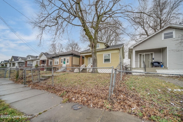 bungalow with a fenced front yard, a gate, and a residential view