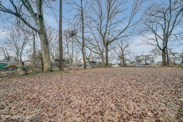 view of yard featuring a residential view and fence