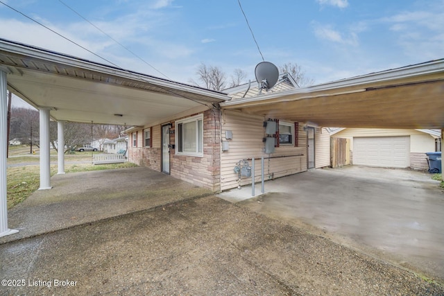 exterior space featuring driveway, a porch, and a carport