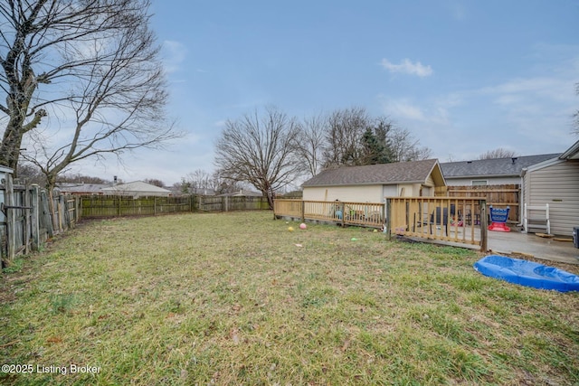 view of yard with a patio area, a fenced backyard, and a wooden deck