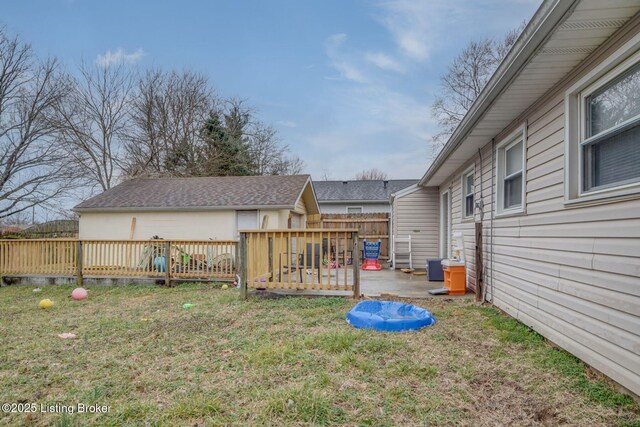 view of yard with a patio area, fence, and a wooden deck