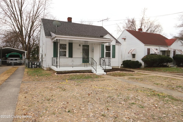 bungalow-style home featuring a carport and a porch