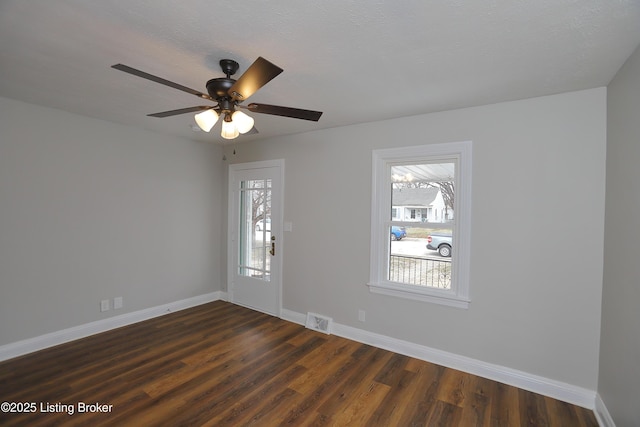 empty room featuring dark hardwood / wood-style flooring and ceiling fan