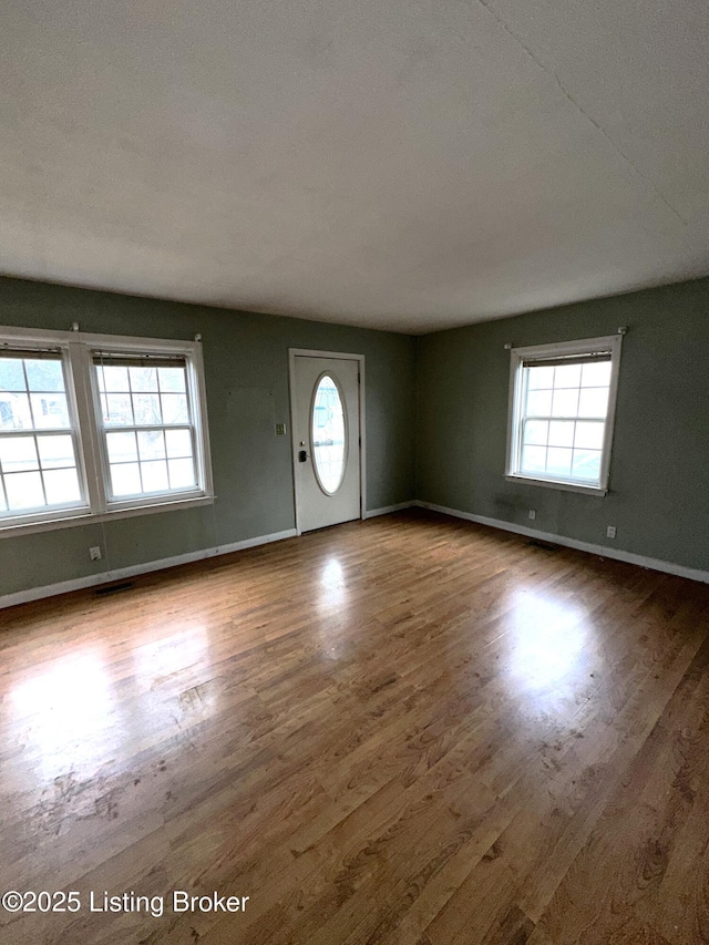 entryway with wood finished floors and baseboards