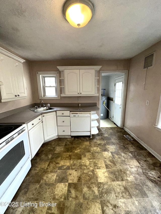 kitchen featuring open shelves, white appliances, a sink, and visible vents