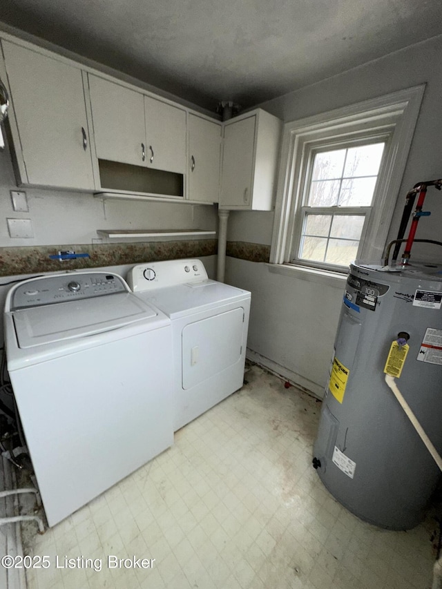 laundry room featuring water heater, light floors, independent washer and dryer, and cabinet space