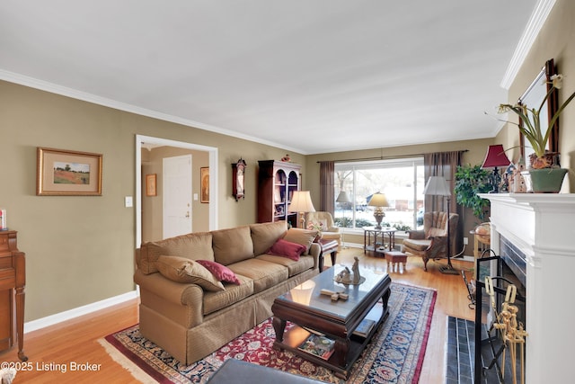 living room with ornamental molding and light hardwood / wood-style floors