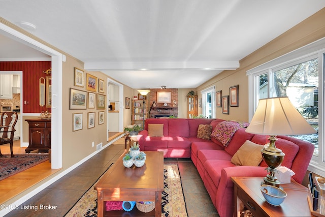 tiled living room featuring a fireplace, crown molding, and beam ceiling