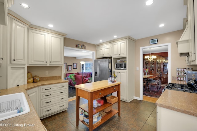 kitchen featuring a chandelier, stainless steel appliances, and sink