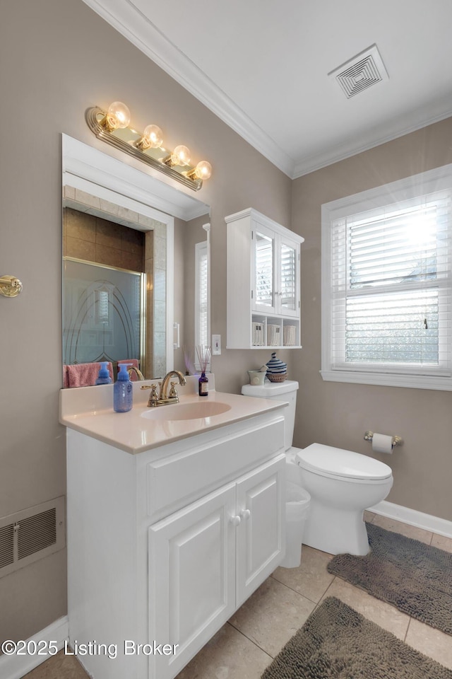 bathroom with tile patterned floors, toilet, vanity, and crown molding