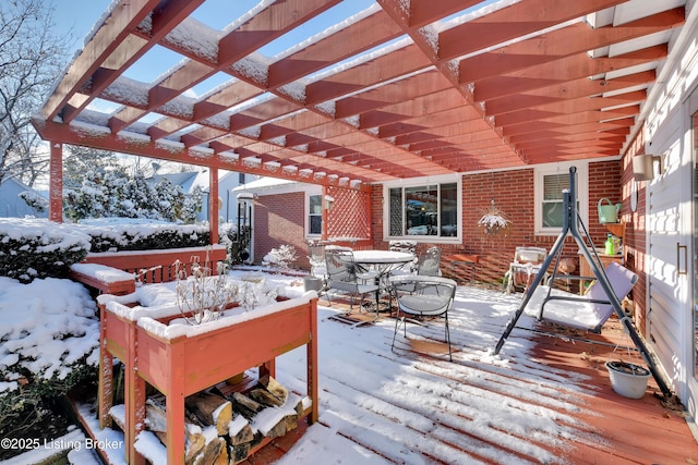 snow covered deck featuring a pergola