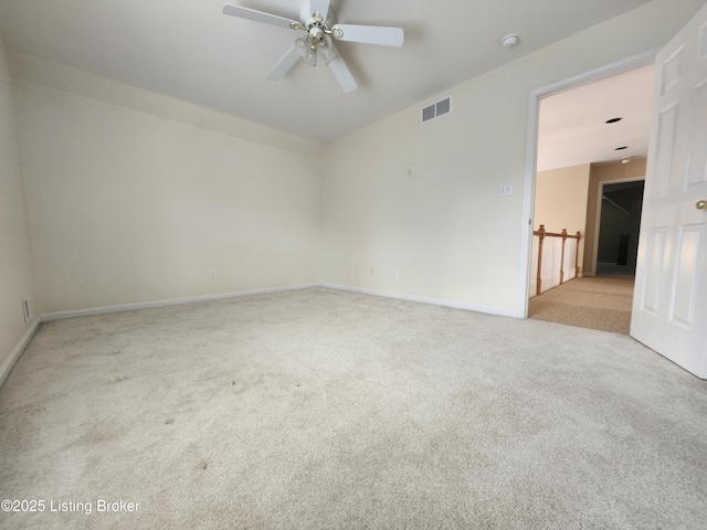 carpeted empty room featuring ceiling fan