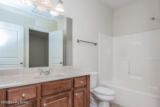 bathroom with tub / shower combination, vanity, and toilet