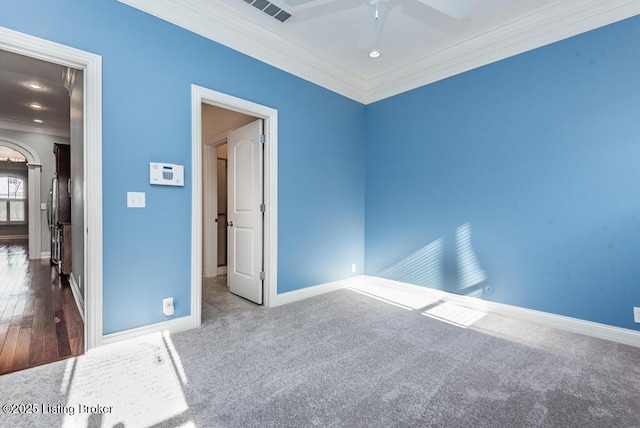 interior space with ornamental molding, visible vents, and baseboards