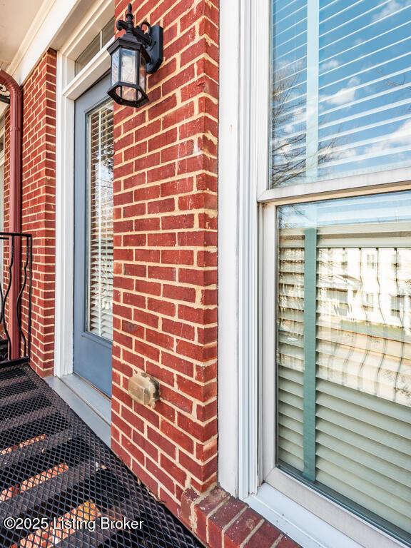 doorway to property with brick siding