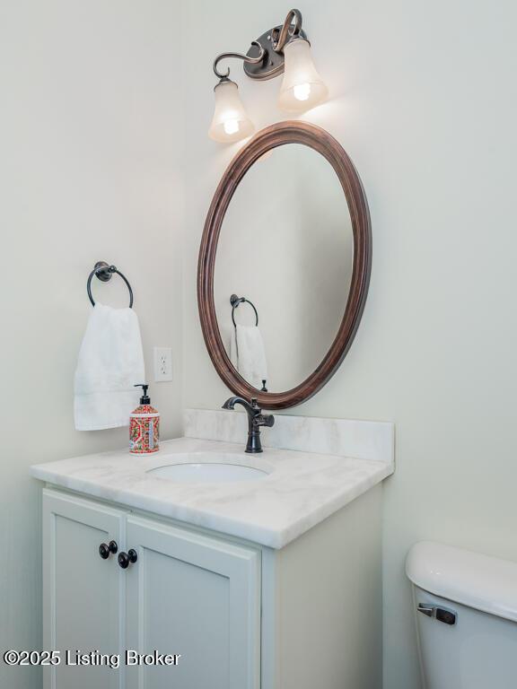 bathroom featuring toilet and vanity