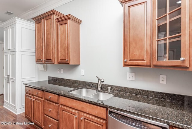 kitchen featuring a sink, glass insert cabinets, brown cabinetry, and dishwasher