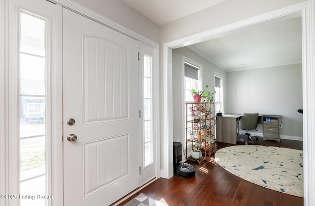 entrance foyer with dark wood-style flooring and baseboards