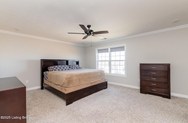 carpeted bedroom with crown molding, baseboards, and ceiling fan