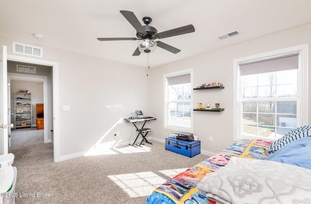 carpeted bedroom with visible vents and baseboards