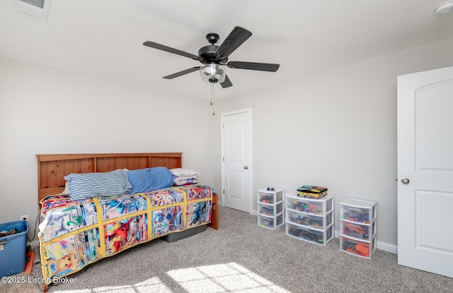 carpeted bedroom with visible vents and a ceiling fan