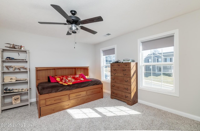 bedroom featuring ceiling fan, carpet floors, visible vents, and baseboards