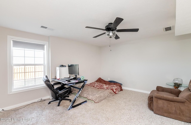 office with a ceiling fan, carpet, visible vents, and baseboards