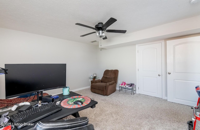 interior space featuring a ceiling fan, carpet, visible vents, and a textured ceiling