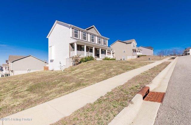 view of front facade featuring a porch and a front lawn