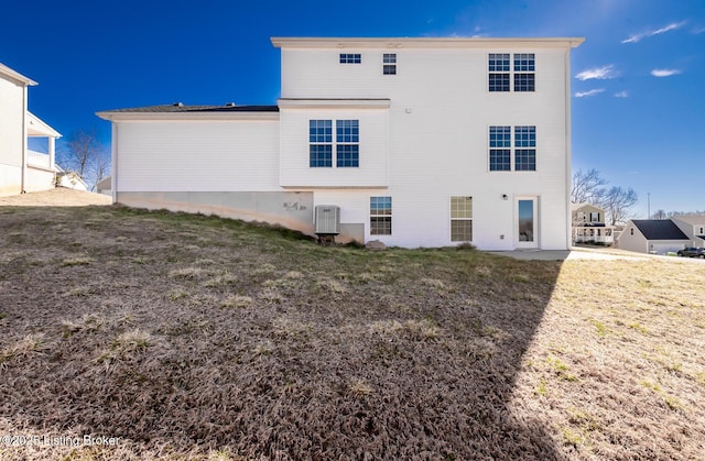 rear view of property featuring a lawn