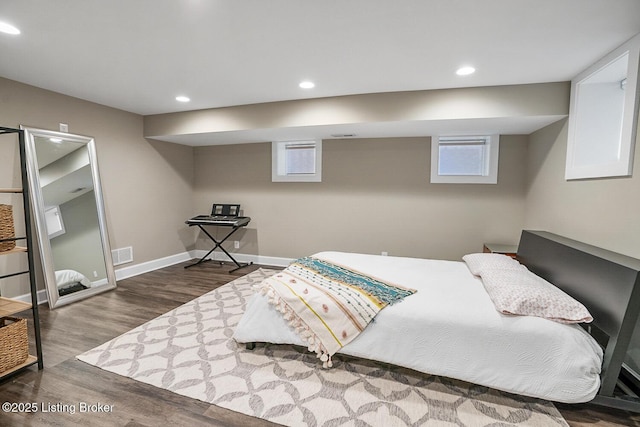 bedroom with dark hardwood / wood-style flooring