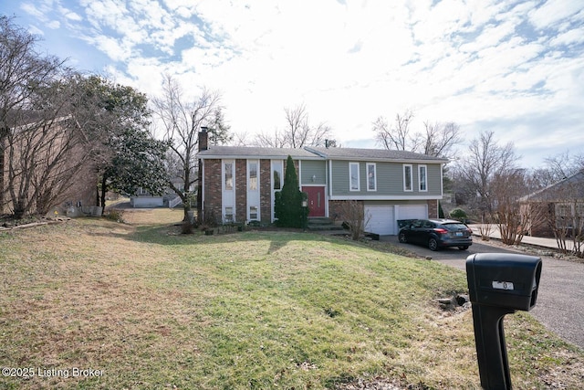 raised ranch featuring aphalt driveway, an attached garage, brick siding, a chimney, and a front yard