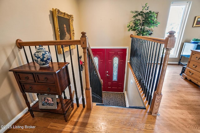 entryway with light wood finished floors and baseboards