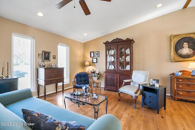 living room featuring recessed lighting, light wood-type flooring, and a healthy amount of sunlight