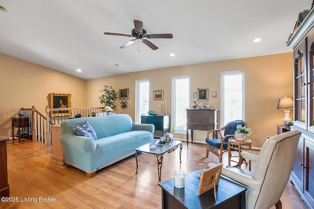 living area featuring light wood finished floors, baseboards, a ceiling fan, and recessed lighting