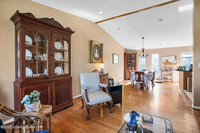 living area featuring light wood finished floors, baseboards, lofted ceiling, a notable chandelier, and recessed lighting