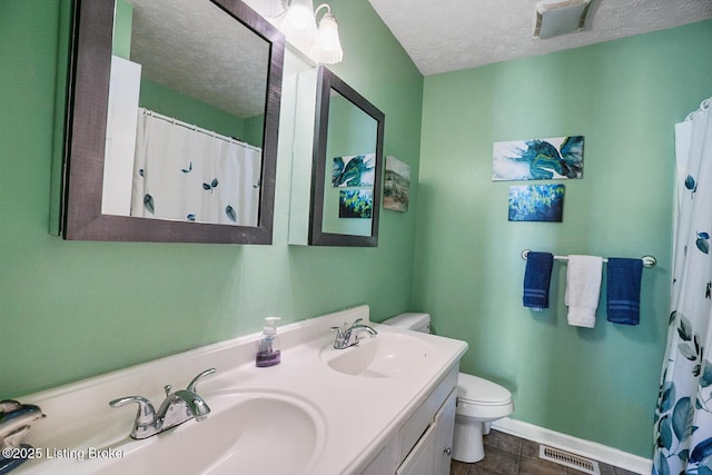 full bathroom featuring toilet, a textured ceiling, visible vents, and a sink