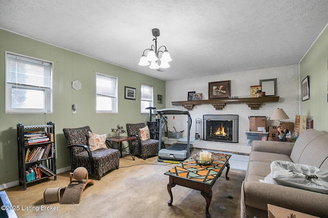 living area with a fireplace, a chandelier, and a textured ceiling