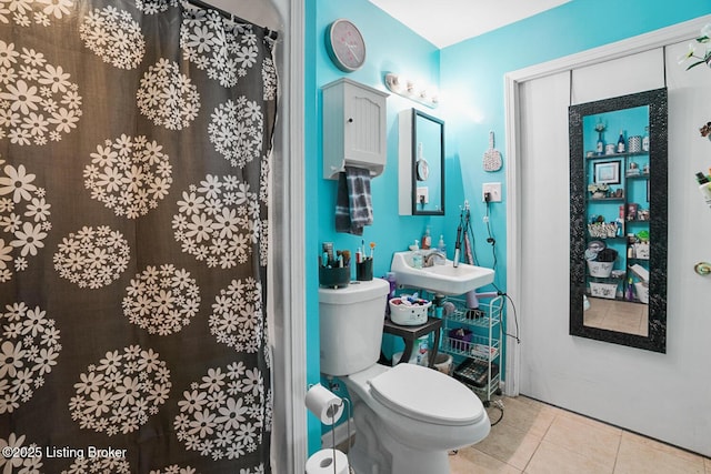 full bathroom with tile patterned flooring, a sink, and toilet