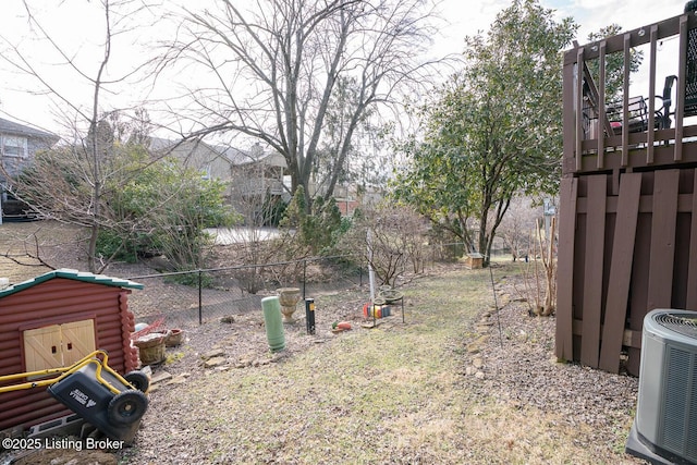 view of yard with central AC and a fenced backyard