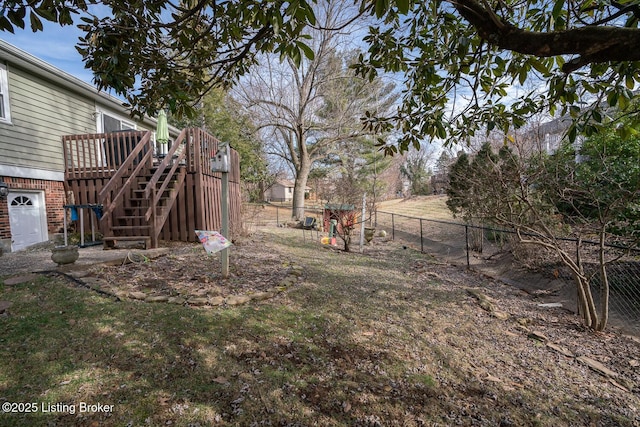 view of yard with stairway, fence, and a wooden deck